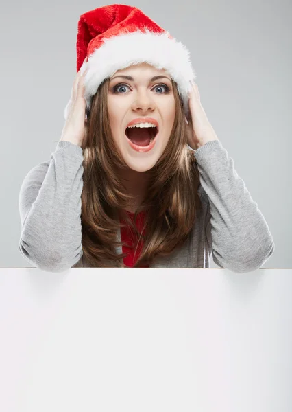 Vrouw in Kerstman hoed, bedrijf leeg — Stockfoto