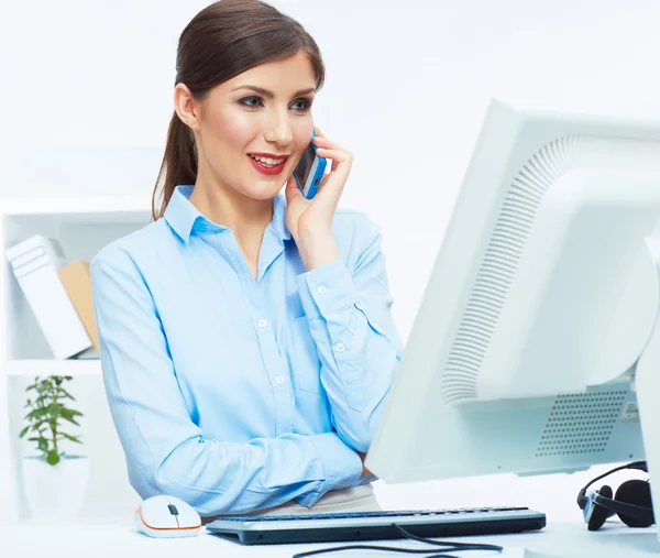 Portrait of young businesswoman in office on phone. — Stock Photo, Image