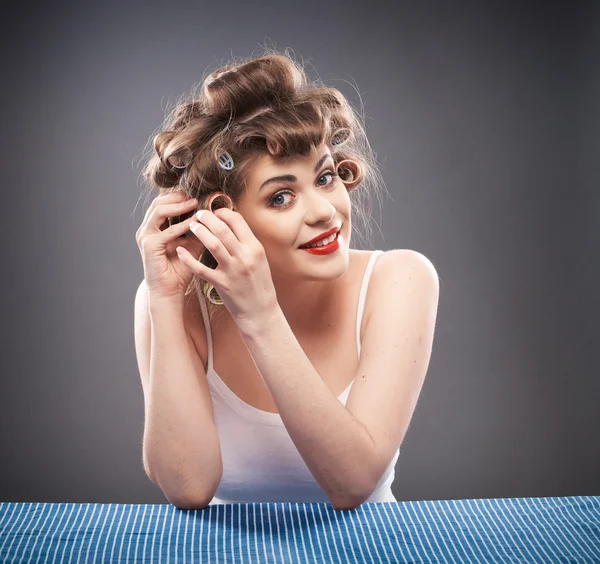 Portrait of a young woman with curlers — Stock Photo, Image