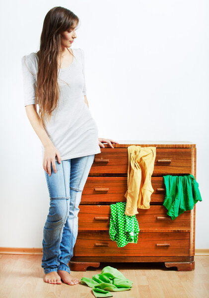 Young woman with clothes at home