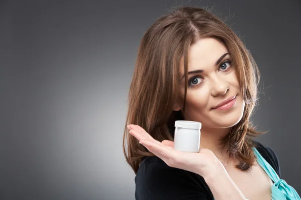 Woman holding cosmetic container — Stock Photo, Image