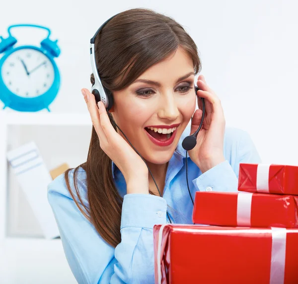 Smiling operator seat at table with red gift box. Happy busines — Stock Photo, Image