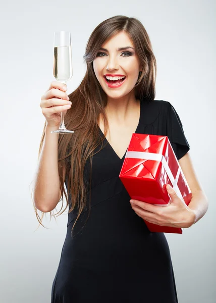 Woman holding gift box and glass of champagne Royalty Free Stock Photos