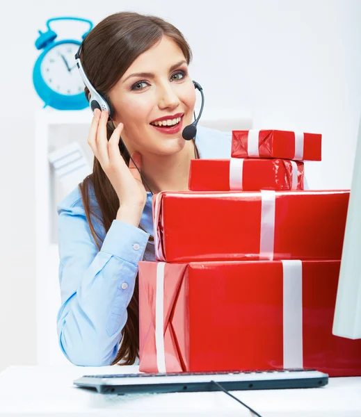 Smiling operator with red gift boxes — Stock Photo, Image