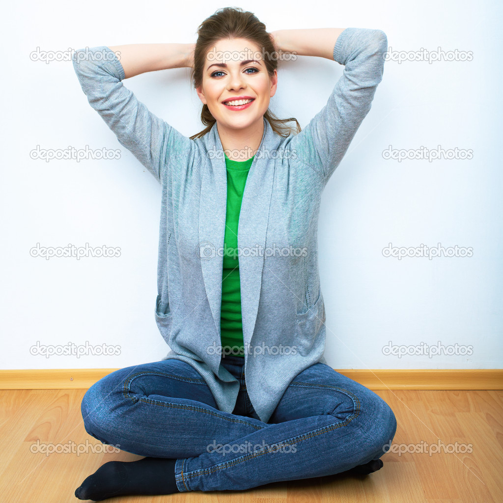 Woman sitting on a floor.