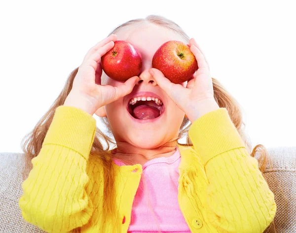 Child girl with red apple on eyes. — Stock Photo, Image