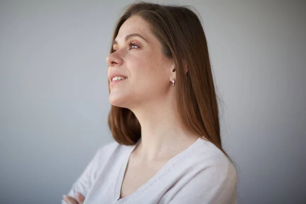 Focused thinking woman close up face portrait. Girl looking away, at side. Female head shot with shallow depth of field.