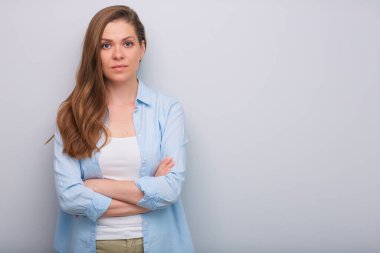 Ciddi bir kadın kollarını kavuşturmuş, izole bir portre..