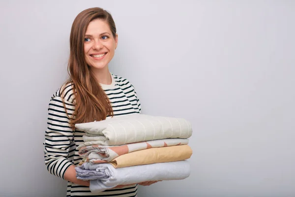 Smiling Woman Isolated Portrait Folded Clothes Stack Looking Away — Stock Photo, Image