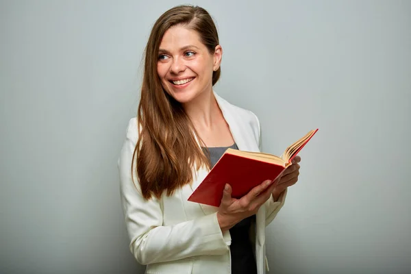 Teacher or female student with red book looking back over shoulders isolated portrait.