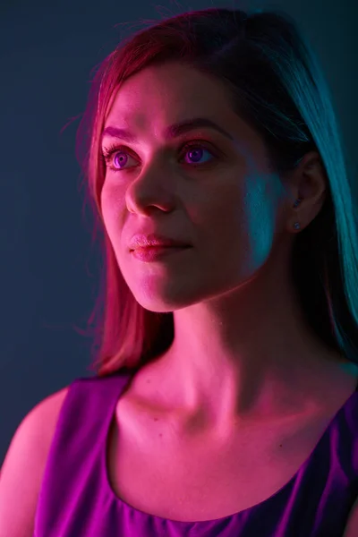 Futuristic look woman with red light, looking away, female face beauty portrait with colored light. natural skin.