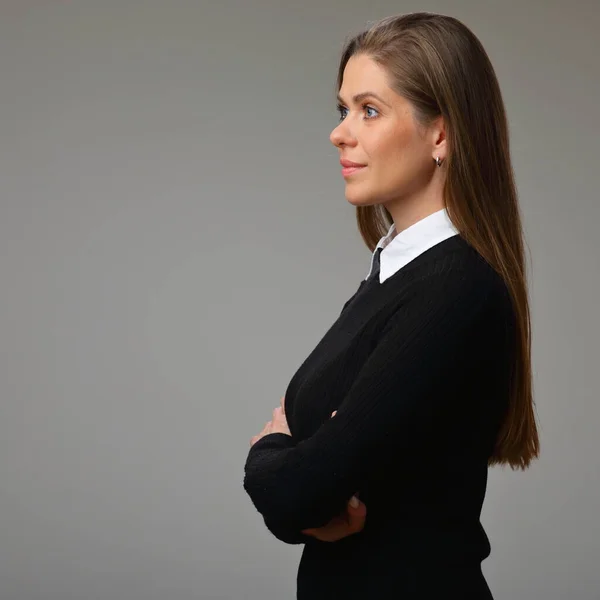 Profile of woman teacher in black business suit with white collar standing with arms crossed, isolated female portrait.