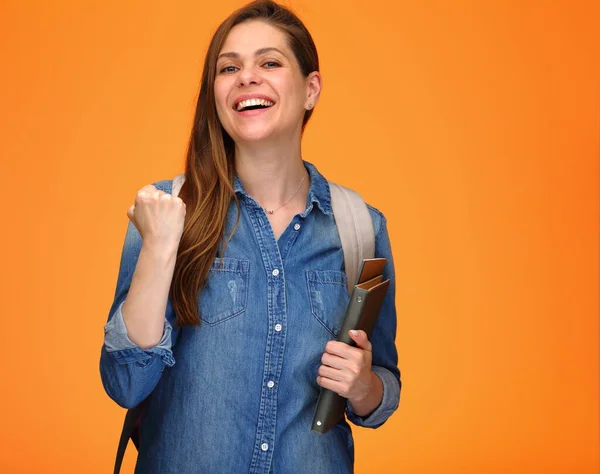 Student woman female power holding book, young lady with backpack isolated portrait on orange back.