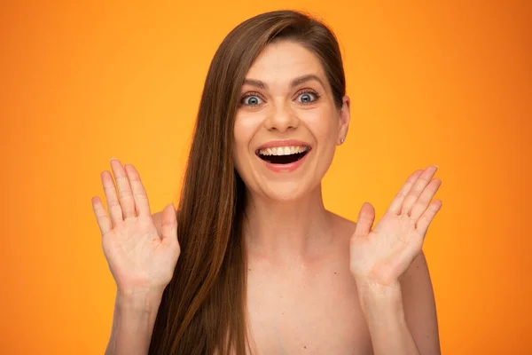 Amazed woman with hands up isolated portrait of amazed girl with bared shoulders and long hair.