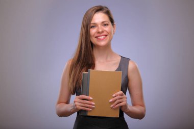 Öğretmen kadın ya da yetişkin öğrenci kitap ya da çalışma kitabıyla ayakta duruyor, izole edilmiş kadın portresi.