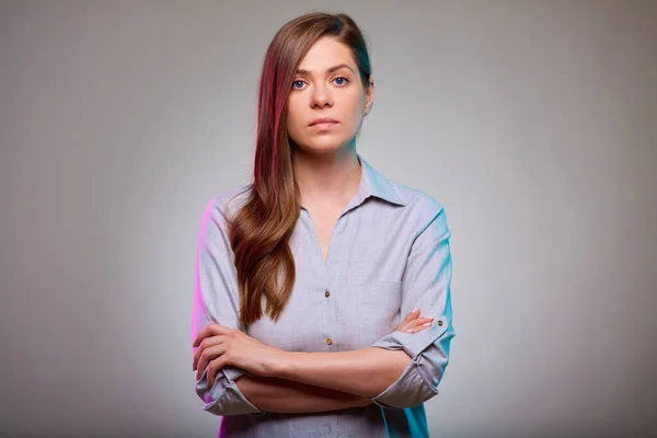 Serious business woman arms crossed, isolated portrait.