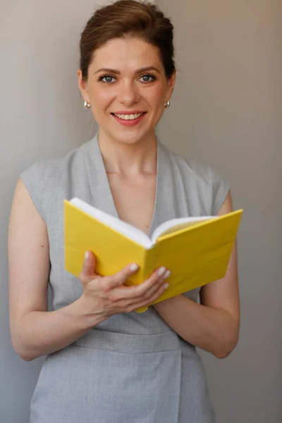 Teacher woman holding open book, or student girl with work book.