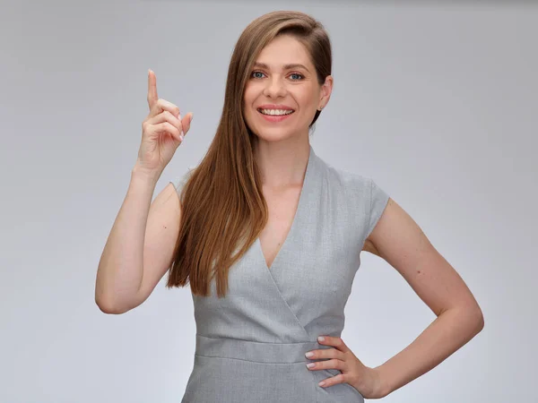Smiling Woman Gray Business Dress Pointing Finger Holding One Hand — Stock Photo, Image