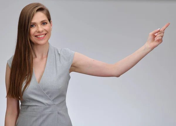 Smiling business woman pointing finger at empty copy space isolated female portrait.