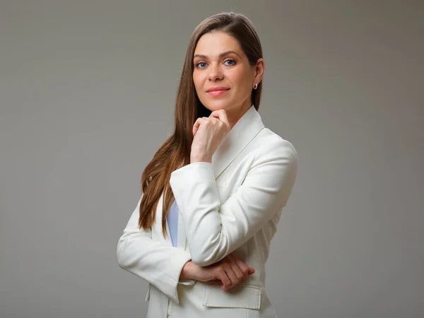 Young business woman in white suit touching her chin studio isolated portrait.