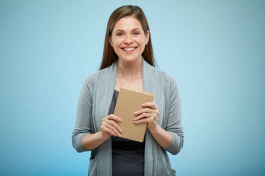 Gülümseyen kadın öğretmen ya da kız öğrenci açık mavi arka planda izole edilmiş portre.