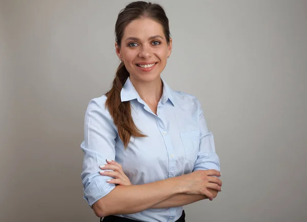 Woman with crossed arms wearing blue business shirt. isolated female portrait.