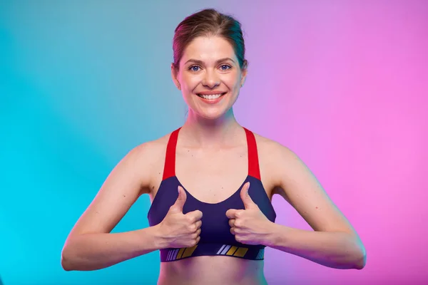 Spor Sutyenli Gülümseyen Bir Kadın Iki Başparmağı Havada Neon Renkli — Stok fotoğraf
