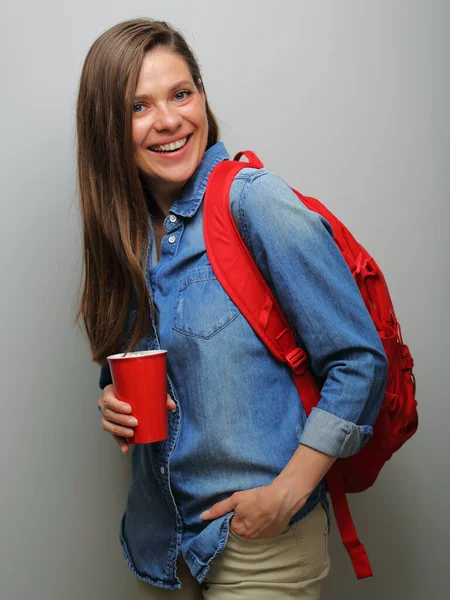 Smiling woman student with red backpack and coffee glass. isolated female portrait.