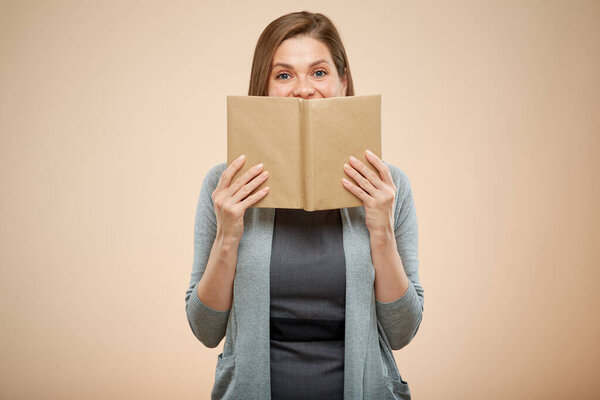 woman teacher or student covered her face with open book, isolated female portrait.