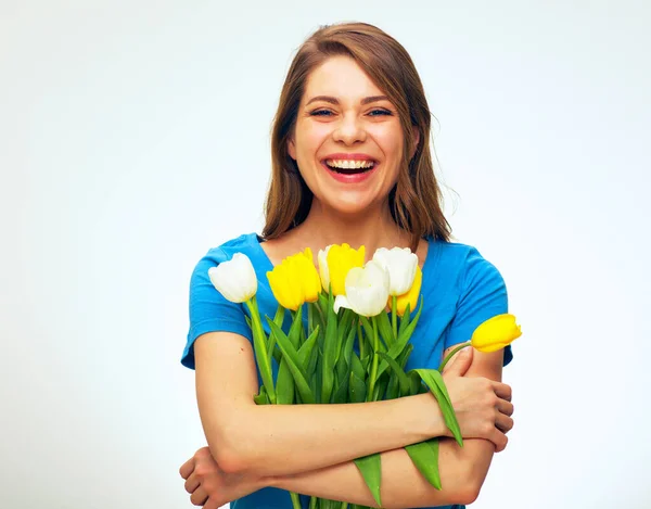 happy woman holding bouquet of tulips in front of. isolated female portrait with big smile.