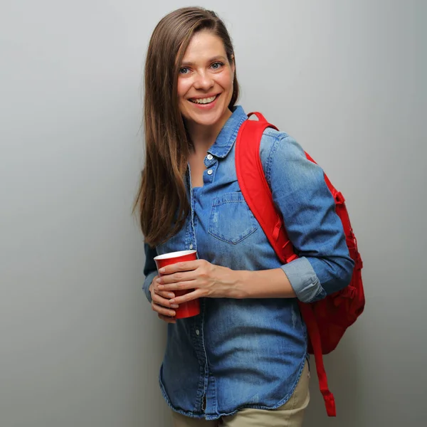 Girl student with red backpack and big coffee glass. isolated female portrait.