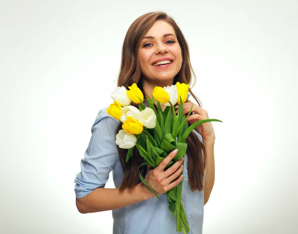 Happy woman holding yellow and white tulips. isolated female portrait in blue shirt.