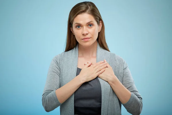 Young woman with hands on heart, chest, isolated female portrait.