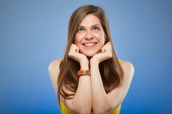 stock image Thinking happy young lady in yellow dress leans face on his hands. isolated female portrait.