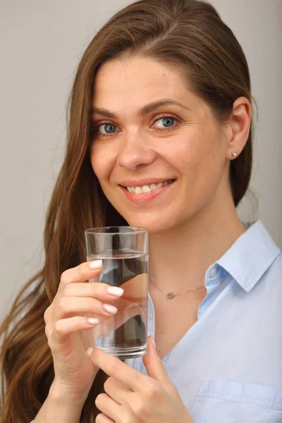 Woman face with water glass close up isolated portrait.