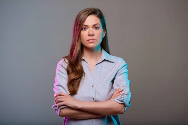 Serious business woman arms crossed, isolated portrait.