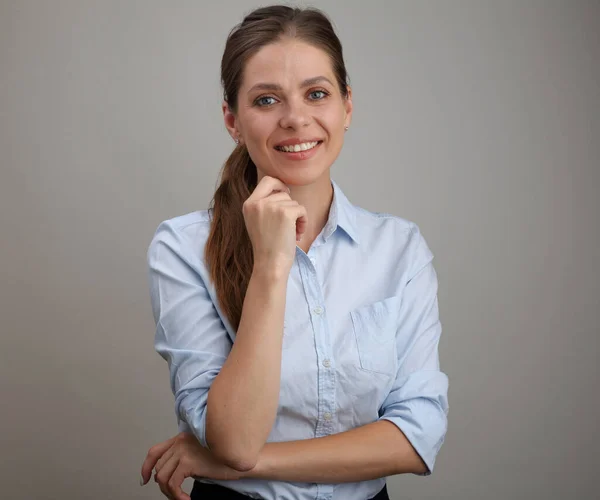 Isolated portrait of smiling young woman wearing blue shirt.