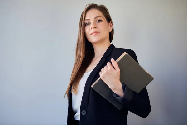 Woman teacher or girl student in black suit holding book.