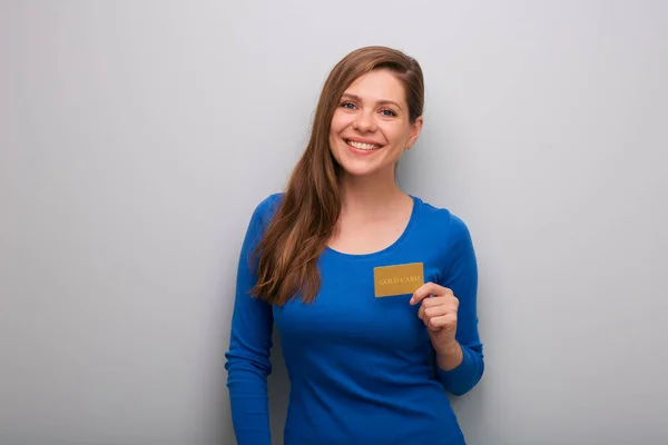 Happy woman holding credit card isolated female portrait. Girl in blue clothes.