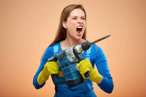 Woman in overalls with punch machine, hard work concept. Isolated portrait female hard worker builder.