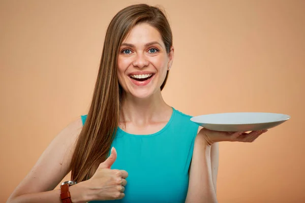 Young Lady Green Dress Holding Empty Plate Shows Thumb Isolated — Stock Photo, Image