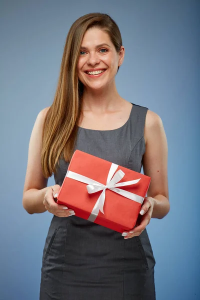 Happy business woman with red gift box studio isolated portrait on blue.