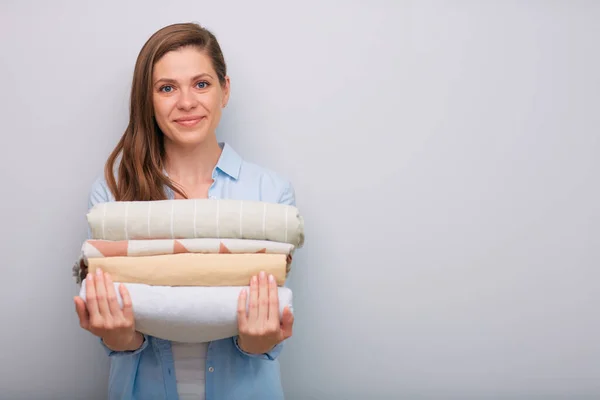Front View Smiling Woman Holding Clothes Stack Bed Sheets Isolated — Stock Photo, Image