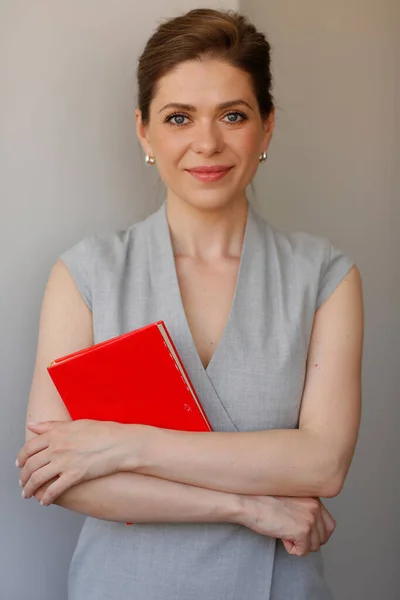 Woman teacher with red book. Isolated person portrait.