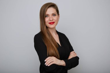 Uzun siyah tişörtlü, gülümseyen genç bir iş kadını kollarını kavuşturmuş, izole edilmiş bir kadın portresi..