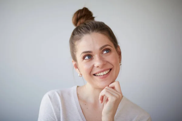 Focused thinking woman close up face portrait. Girl looking away, at side. Female head shot with shallow depth of field.