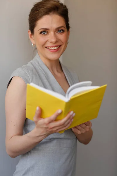 Teacher woman holding open book, or student girl with work book.