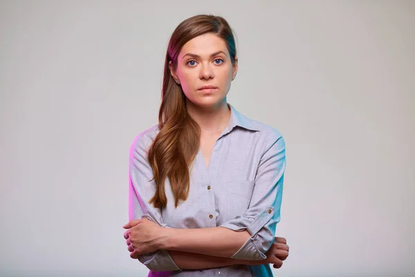 Young confident business woman arms crossed, isolated portrait.