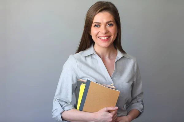 Student woman holding work books. Smiling girl portrait.