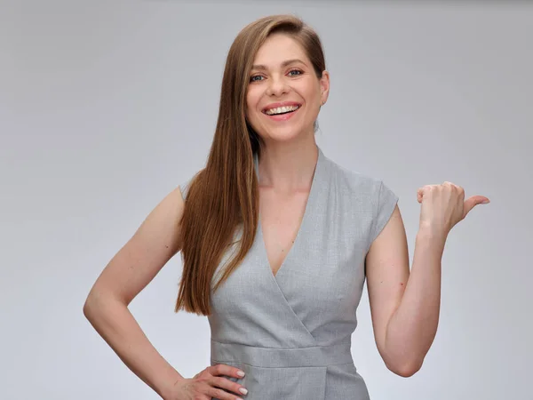 Smiling Business Woman Pointing Thumb Away Isolated Female Portrait Gray — Stock Photo, Image